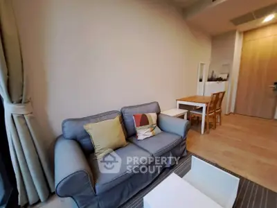 Cozy living room with stylish sofa and dining area in modern apartment