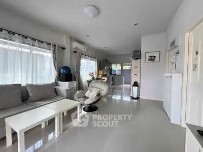 Spacious modern living room with open kitchen layout and natural light
