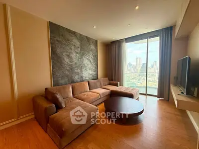 Spacious living room with modern sofa and city view, perfect for urban living.