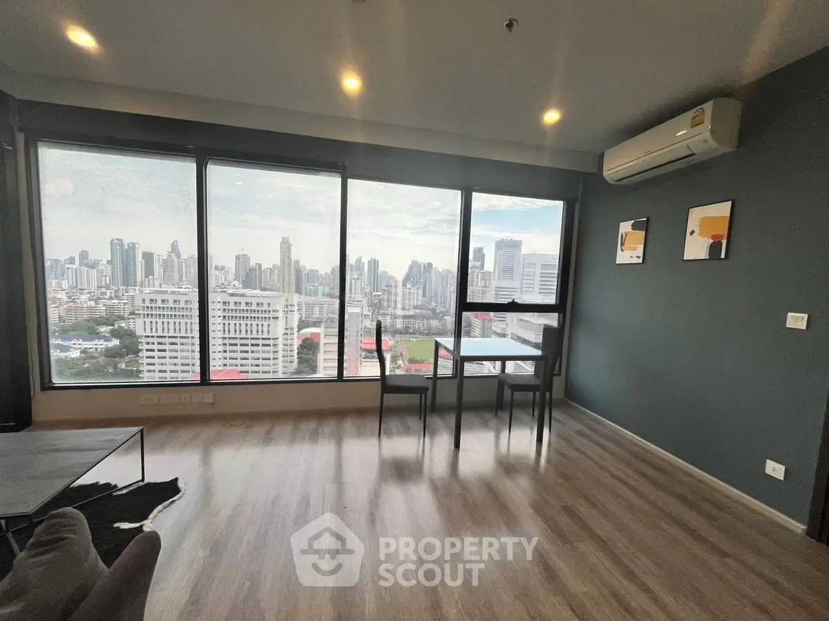 Stunning high-rise living room with panoramic city views and modern decor.