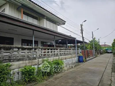 Charming suburban house with spacious outdoor area and lush greenery, perfect for family living.