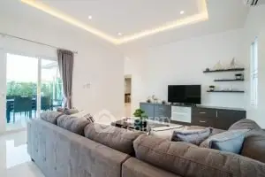 Spacious modern living room with elegant decor and large windows for natural light.