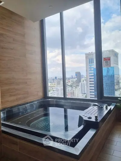 Luxurious bathroom with city view and modern jacuzzi tub in high-rise apartment.
