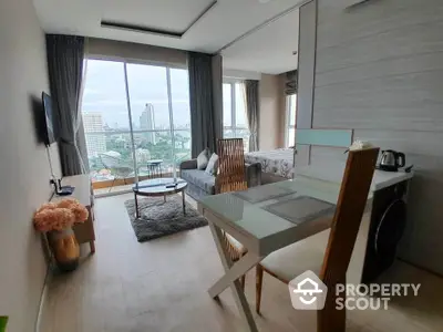 Modern studio apartment with city view, featuring open layout and stylish furnishings.