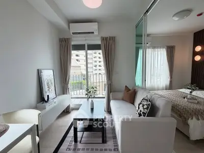 Modern studio apartment with open layout, stylish decor, and balcony view.