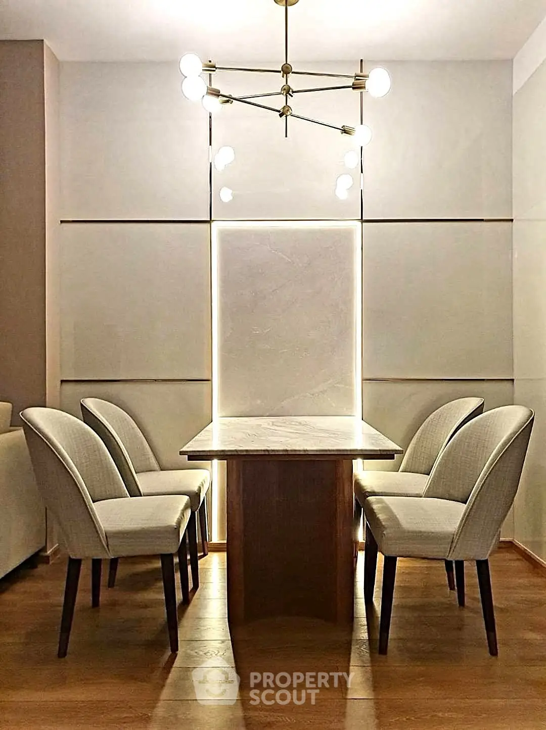 Elegant dining area with modern chandelier and stylish chairs around a sleek table, perfect for contemporary living.