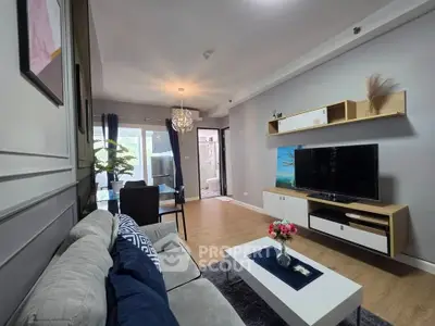Modern living room with stylish decor and open layout, featuring a cozy seating area and dining space.
