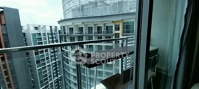 Modern high-rise balcony with stunning city view and sleek glass railing.