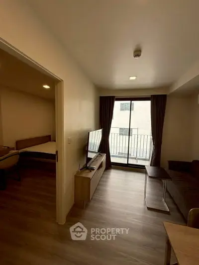 Modern apartment living room with balcony access and sleek furnishings