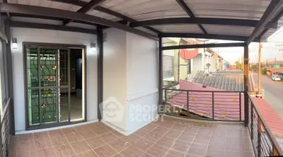 Spacious balcony with metal railing and tiled floor, perfect for relaxation.