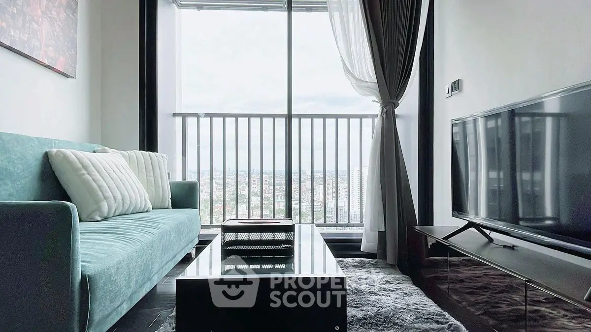 Modern living room with stunning city view, featuring a sleek sofa and large TV, perfect for urban living.