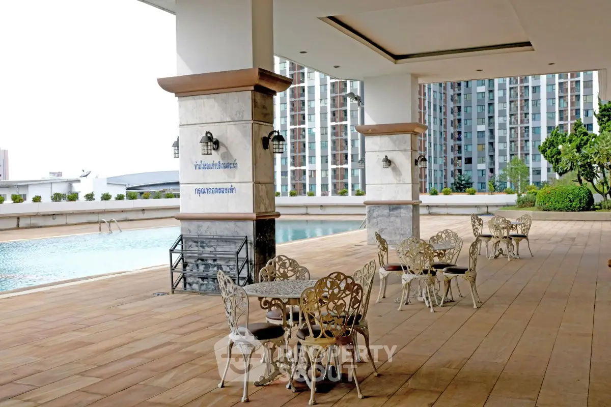 Luxurious rooftop pool area with stylish seating and stunning city views.