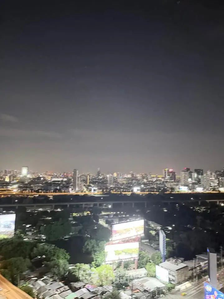 Stunning cityscape view from a high-rise building at night, showcasing vibrant urban lights and skyline.