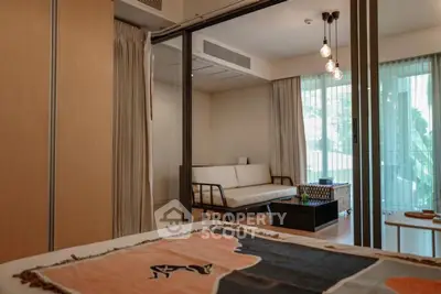 Modern bedroom with sliding glass doors and cozy seating area