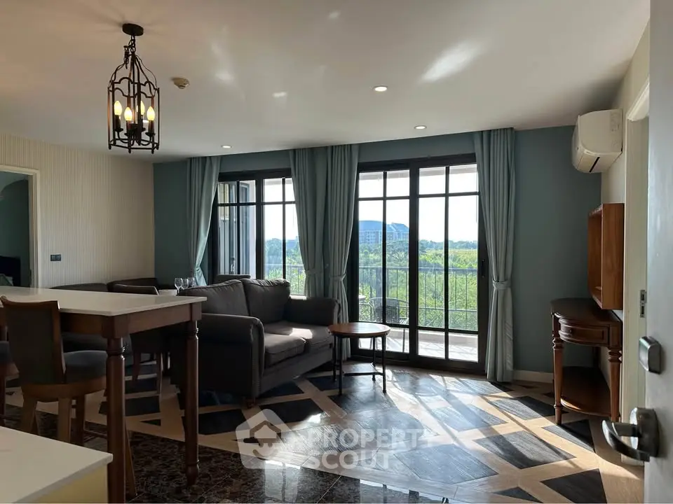 Spacious living room with elegant decor and stunning view through large windows.