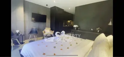 Luxurious bedroom with modern decor and elegant swan towel arrangement