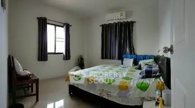 Cozy bedroom with modern decor and ample natural light