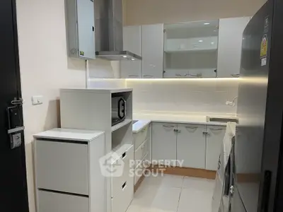 Modern kitchen with sleek white cabinets and stainless steel appliances