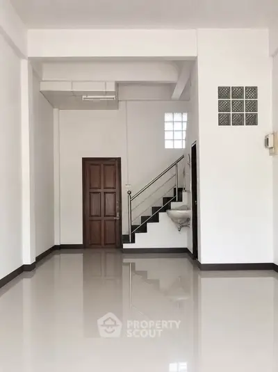 Spacious interior with staircase and polished floors, ideal for modern living.