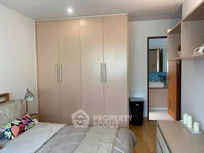 Spacious bedroom with large wardrobe and modern decor