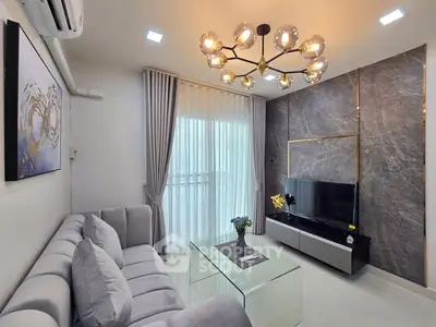 Modern living room with elegant chandelier and stylish decor