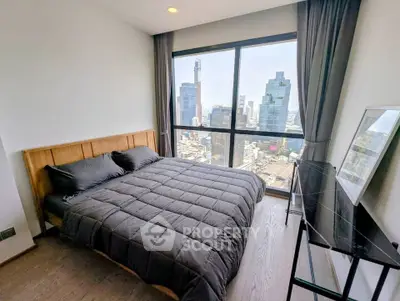 Modern bedroom with stunning city view and large window, featuring sleek furniture and cozy bedding.