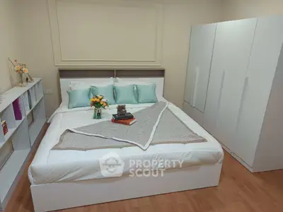 Cozy bedroom with modern white furniture and elegant decor, perfect for relaxation and comfort.