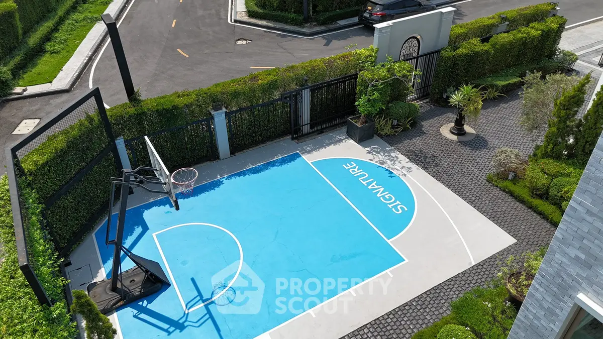 Luxurious residential property with private basketball court and lush greenery.