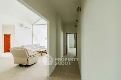 Spacious modern living room with white walls and comfortable seating