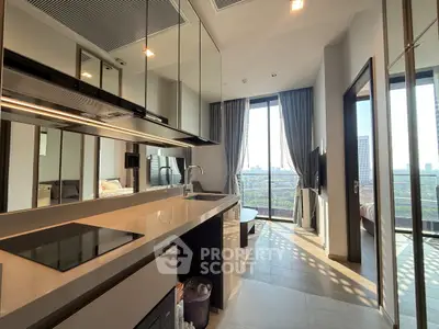 Modern open-layout kitchen with sleek design and city view, featuring high-end appliances and ample natural light.