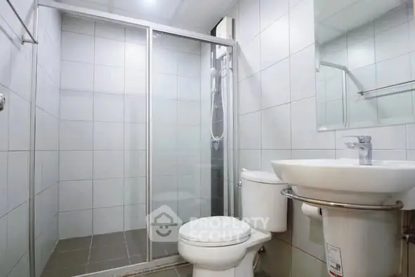 Modern bathroom with glass shower and sleek fixtures