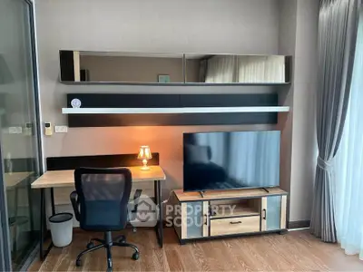 Modern study area with desk, chair, and large TV in stylish apartment