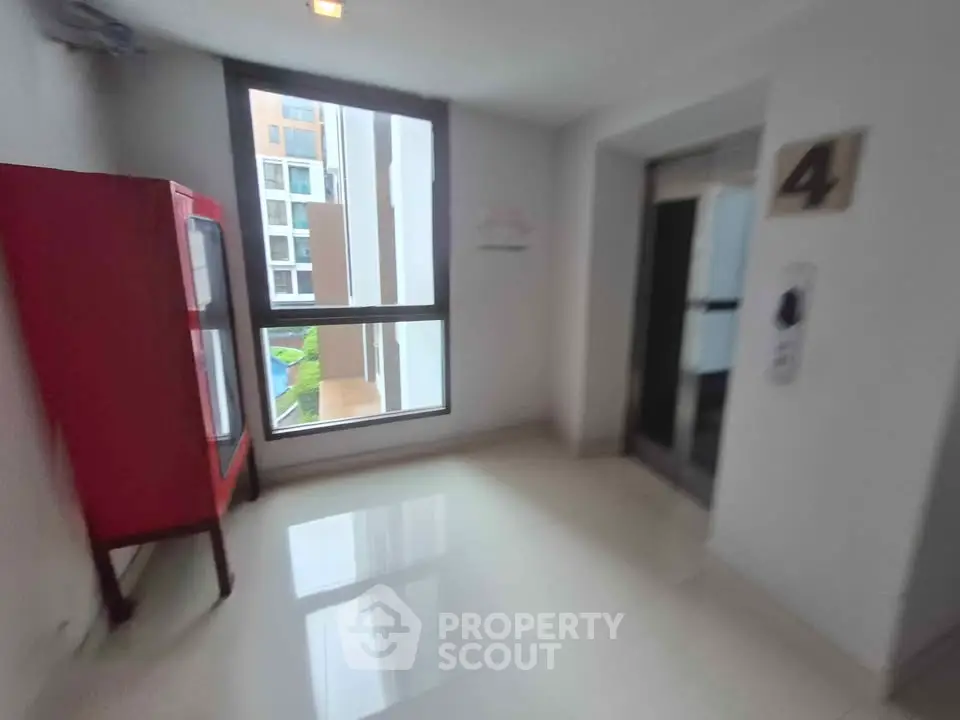 Modern building corridor with elevator and large window view