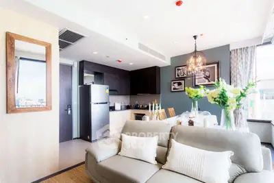 Modern living room with open kitchen, elegant decor, and city view, perfect for urban living.