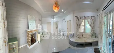 Spacious living room with elegant chandelier and cozy seating area, perfect for family gatherings.