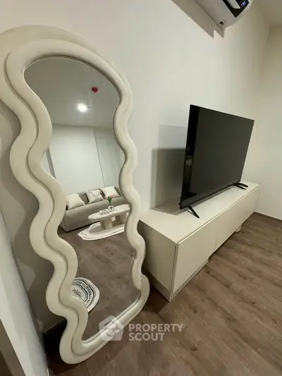 Modern living room with stylish mirror and sleek TV setup