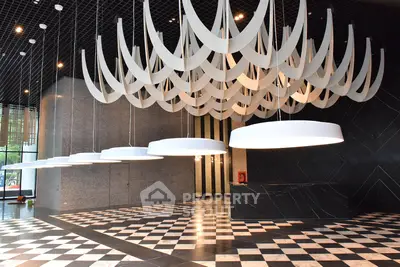 Luxurious modern building entrance with unique lighting and checkered flooring