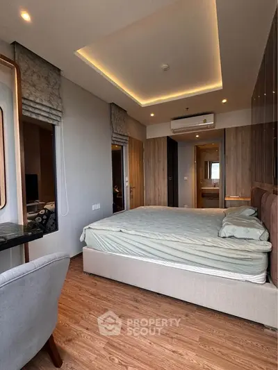 Modern bedroom with stylish decor and wooden flooring in a luxury apartment.