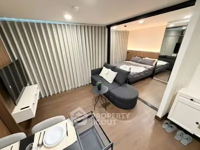 Modern studio apartment with open layout, featuring cozy living area and stylish bedroom.