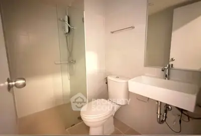 Modern bathroom with glass shower and sleek fixtures in a contemporary apartment.