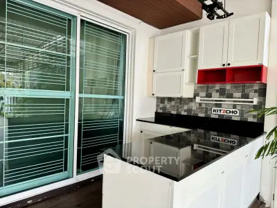 Modern kitchen with sleek black countertops and stylish backsplash