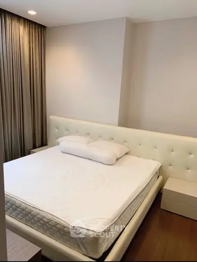 Modern bedroom with elegant design and cozy ambiance, featuring a plush bed and stylish decor.