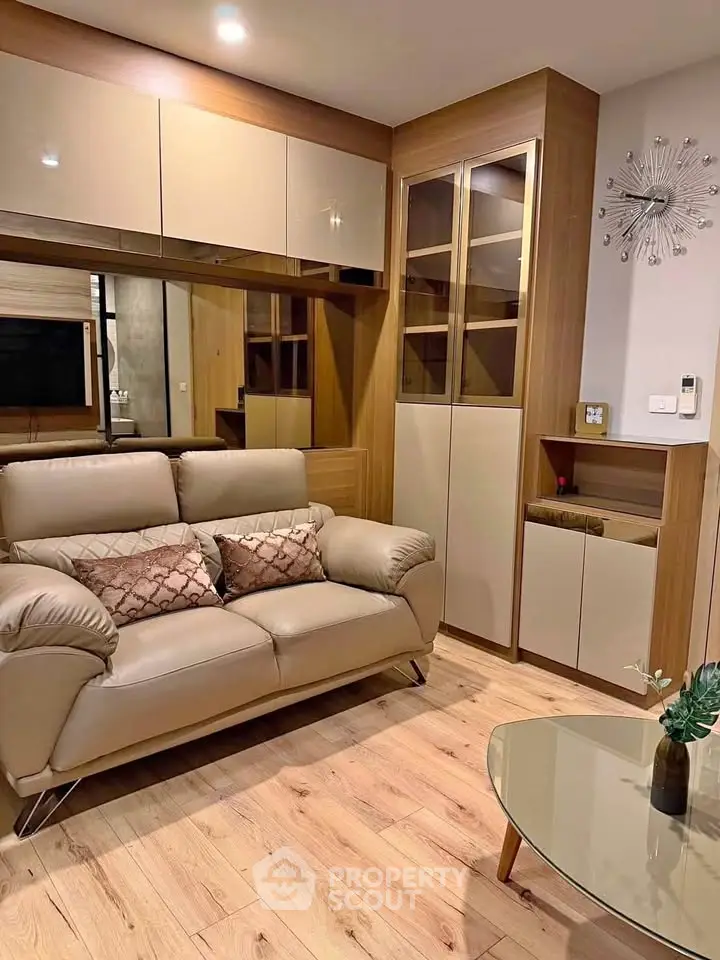 Modern living room with stylish furniture and wooden accents, perfect for cozy relaxation.