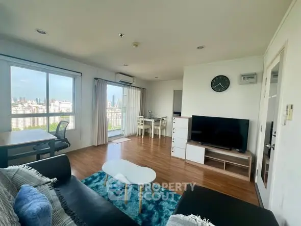 Spacious living room with city view, modern furniture, and natural light.