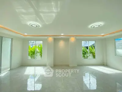 Spacious modern living room with elegant lighting and large windows