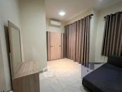 Spacious bedroom with modern furnishings and ample natural light