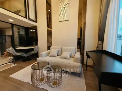 Modern living room with high ceilings and stylish decor in a luxurious apartment.