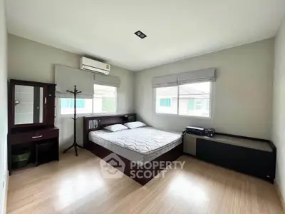 Spacious bedroom with modern furnishings and natural light