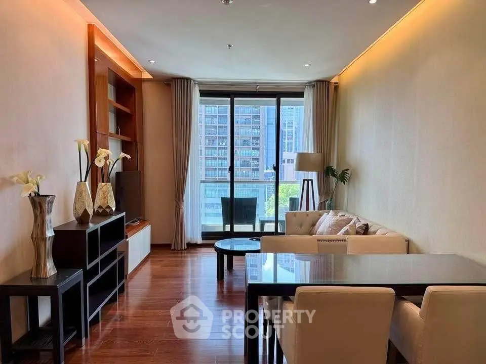 Elegant living room with modern decor and large windows offering city views.