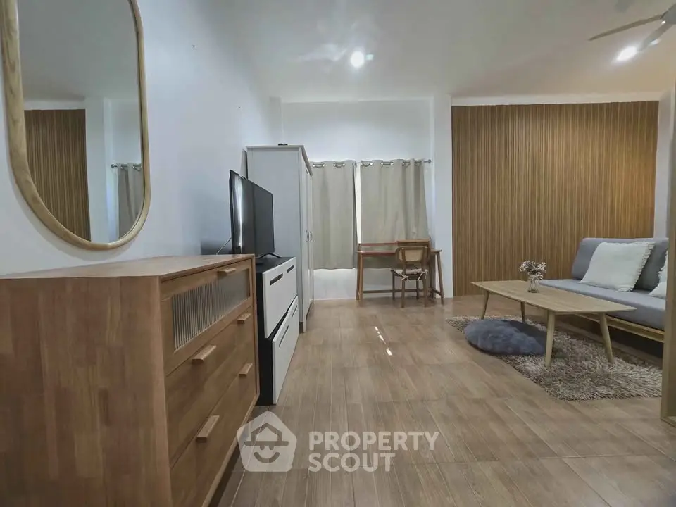 Modern living room with stylish furniture and wooden accents, perfect for cozy relaxation and entertainment.